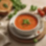 A bowl of creamy tomato soup garnished with fresh basil